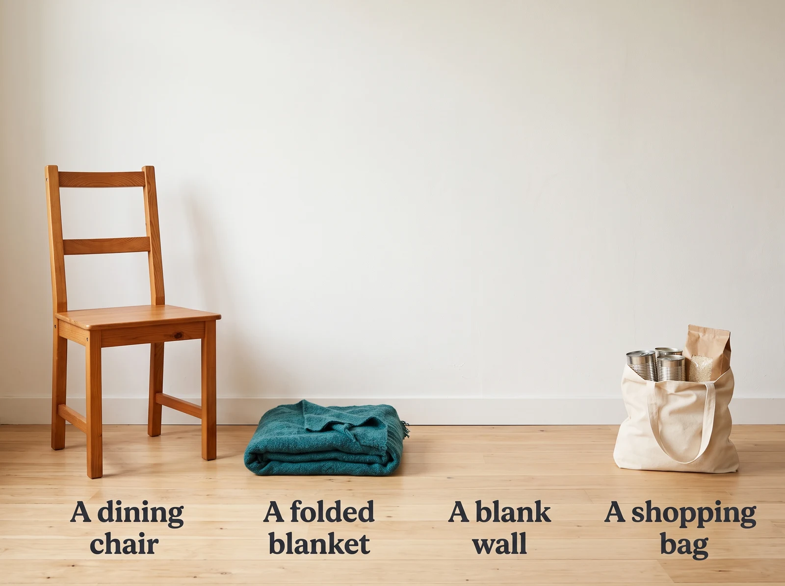 The whole equipment list: a dining chair, a folded blanket, a blank wall and a shopping bag with tins in it.
